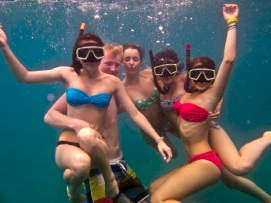 Friends snorkeling posing for the camera underwater