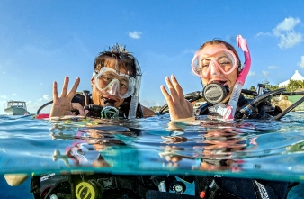 Two divers on the surface signaling OK!