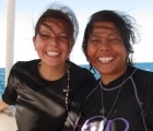 Frequent divers smiling while on the boat trip to the reefs